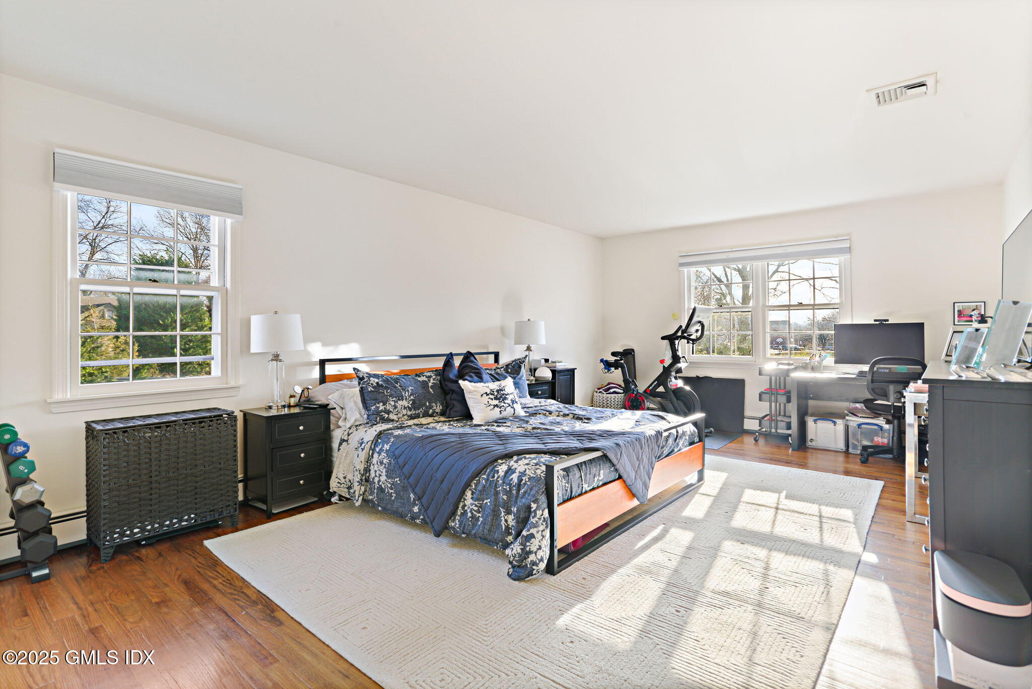 38 A Orchard Street Cos Cob, CT 06807 - Photo 13 of 26 a spacious bedroom with a bed a table and windows