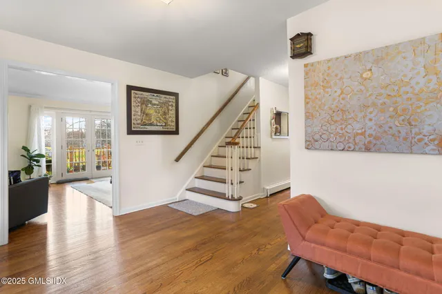 a view of entryway and hall with wooden floor
