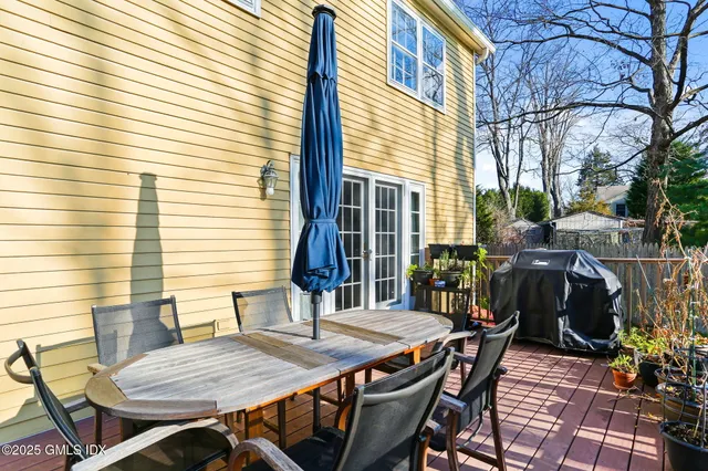 a view of a patio with table and chairs and potted plants