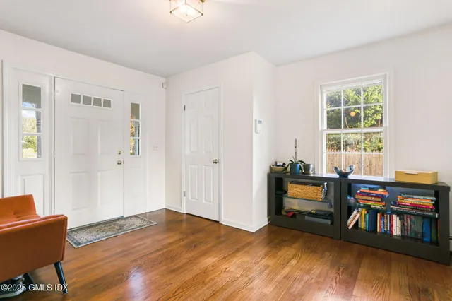 a view of a livingroom with furniture and hardwood floor