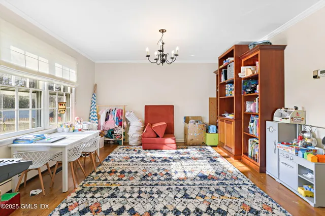 a bedroom with furniture and a chandelier