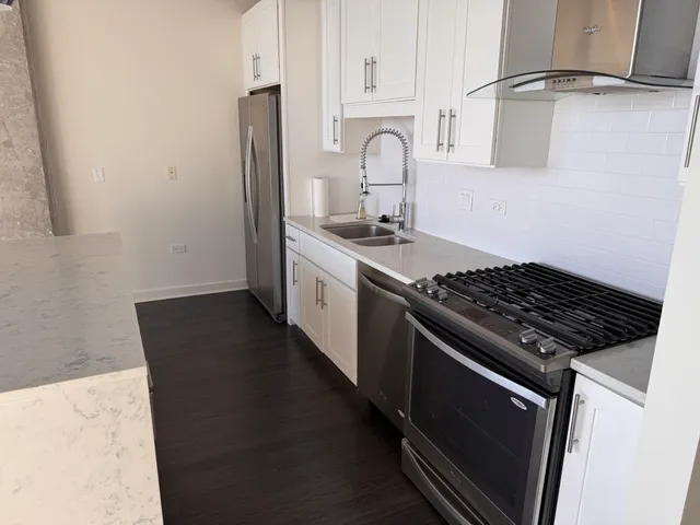 a close view of stove top oven and cabinets