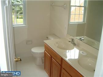 9712 Bridle Road Philadelphia, PA 19115 - Photo 8 of 12 a bathroom with a sink a toilet and a window