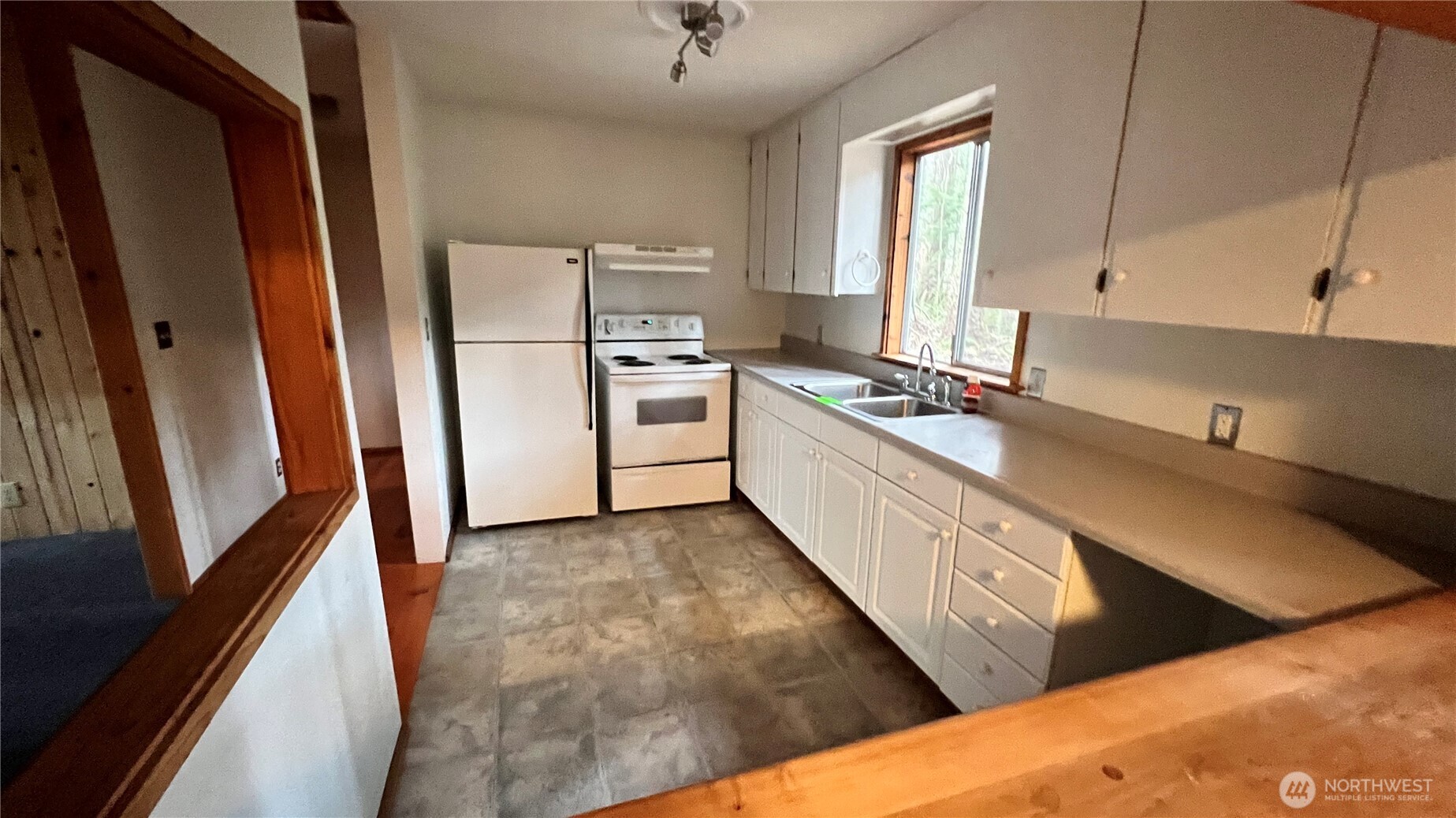 140 Maple Way Packwood, WA 98361 - Photo 5 of 9 a kitchen with granite countertop a refrigerator sink and white cabinets