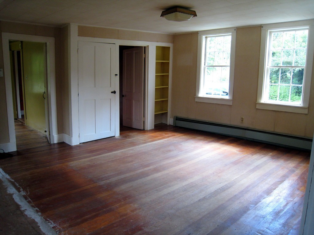 1216 Conway Road Ashfield, MA 01330 - Photo 4 of 30 an empty room with wooden floor and windows