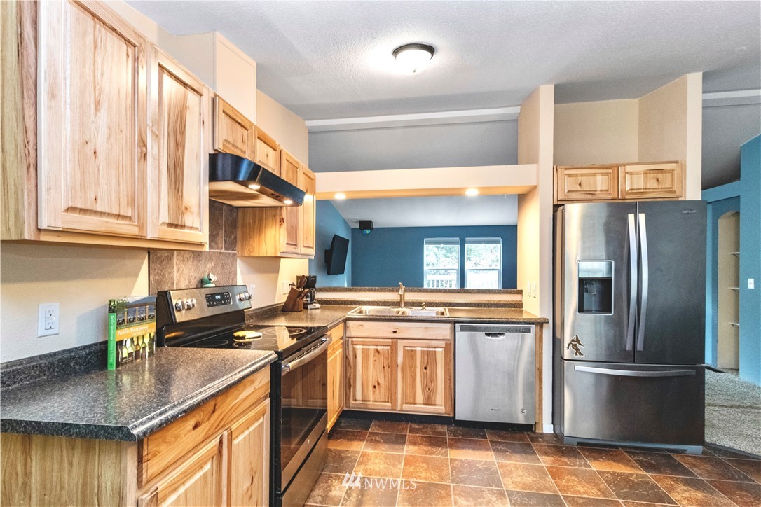 51722 South Riverside Road Gold Bar, WA 98251 - Photo 8 of 27 a kitchen with stainless steel appliances granite countertop a sink a stove and a refrigerator