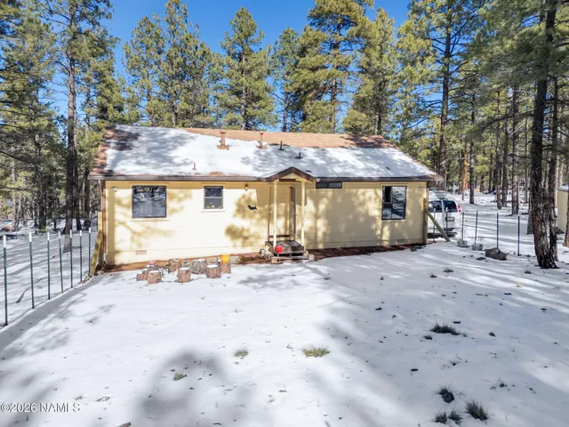 a view of a house with a snow in the yard