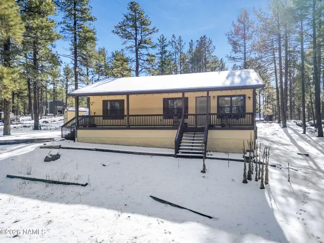a view of a house with backyard porch and sitting area