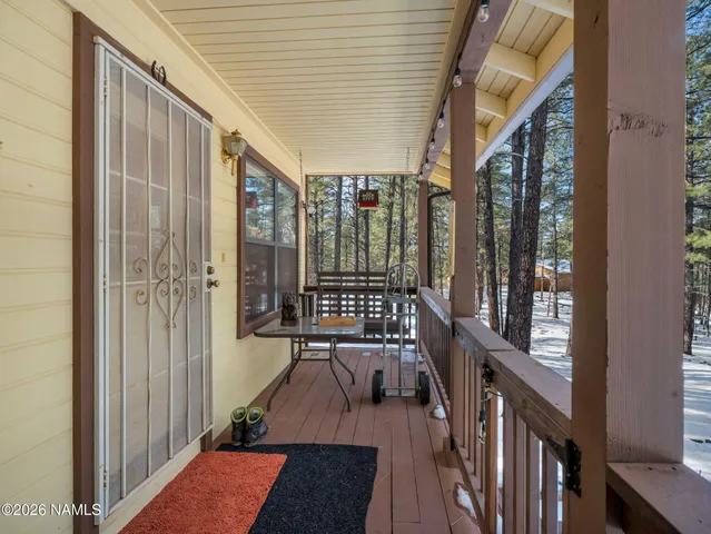 a view of balcony with wooden floor and outdoor seating
