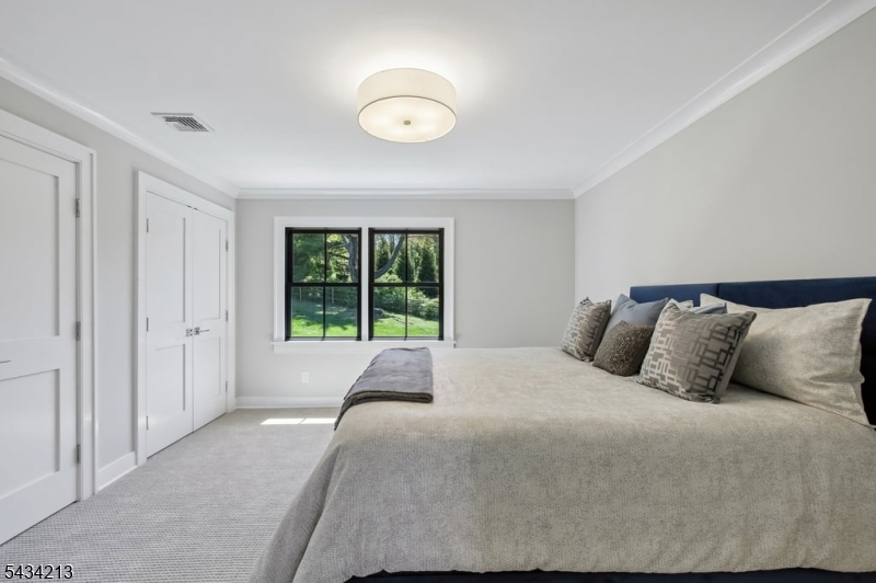 210 Mendham Road Bernardsville, NJ 07924 - Photo 33 of 45 a bedroom with a large bed and a large window