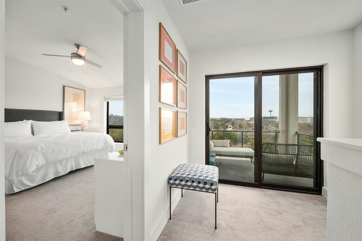 2050 Lohmans Spur Road, Unit 101 Lakeway, TX 78738 - Photo 15 of 31 a bedroom with a bed and a large window