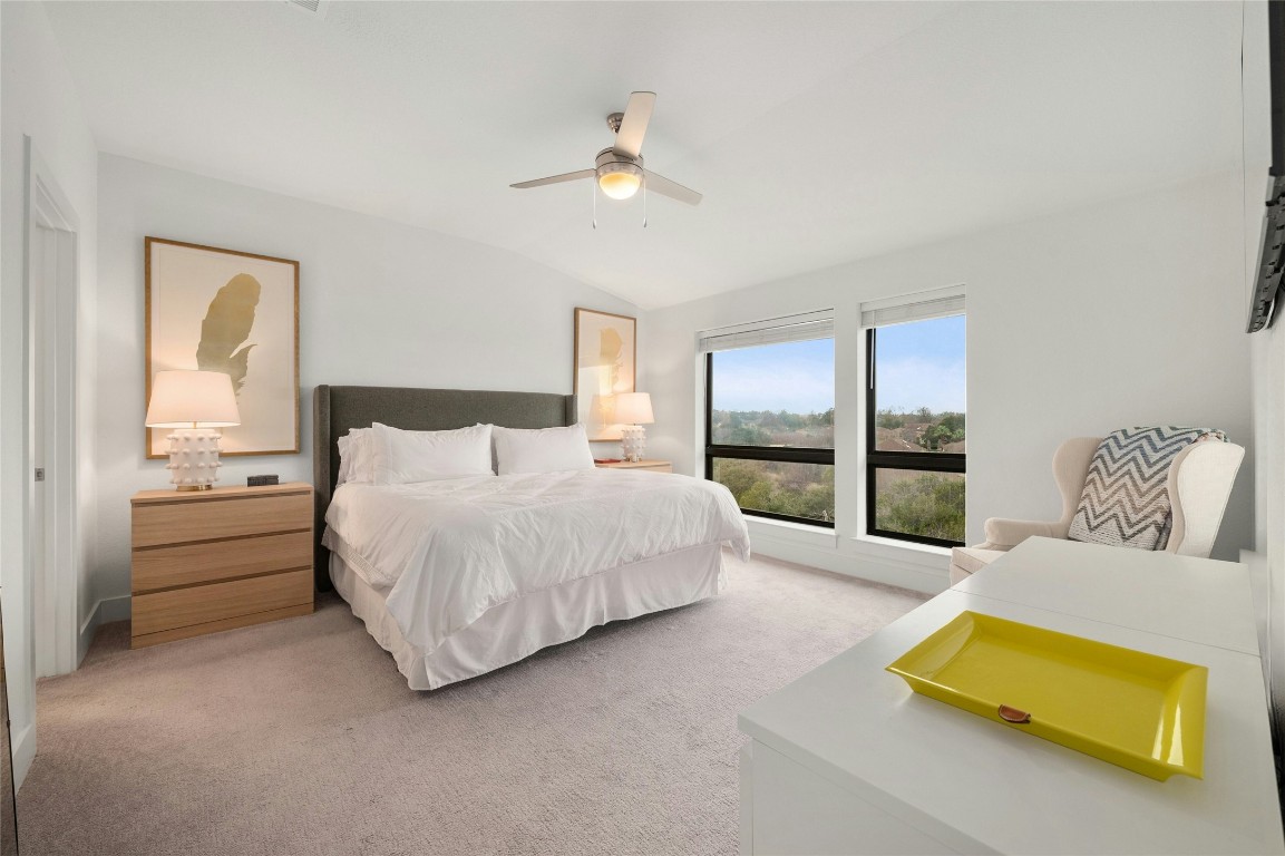 2050 Lohmans Spur Road, Unit 101 Lakeway, TX 78738 - Photo 16 of 31 a spacious bedroom with a bed and a lamp