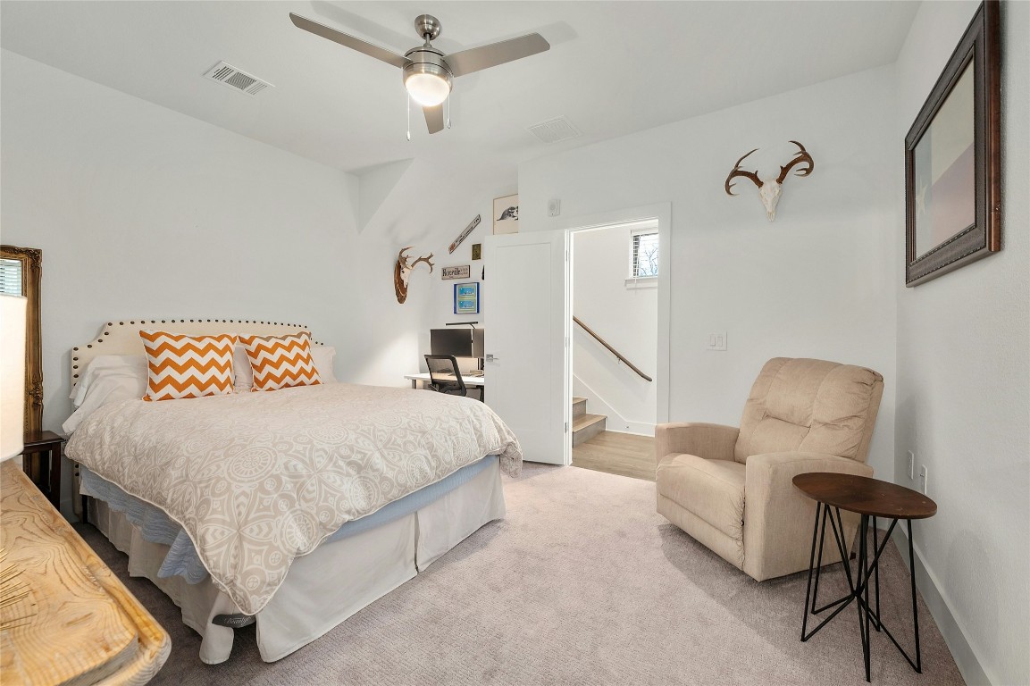 2050 Lohmans Spur Road, Unit 101 Lakeway, TX 78738 - Photo 22 of 31 a bedroom with a bed and chair