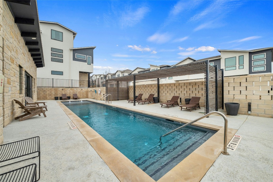 2050 Lohmans Spur Road, Unit 101 Lakeway, TX 78738 - Photo 25 of 31 a view of a house with swimming pool and sitting area