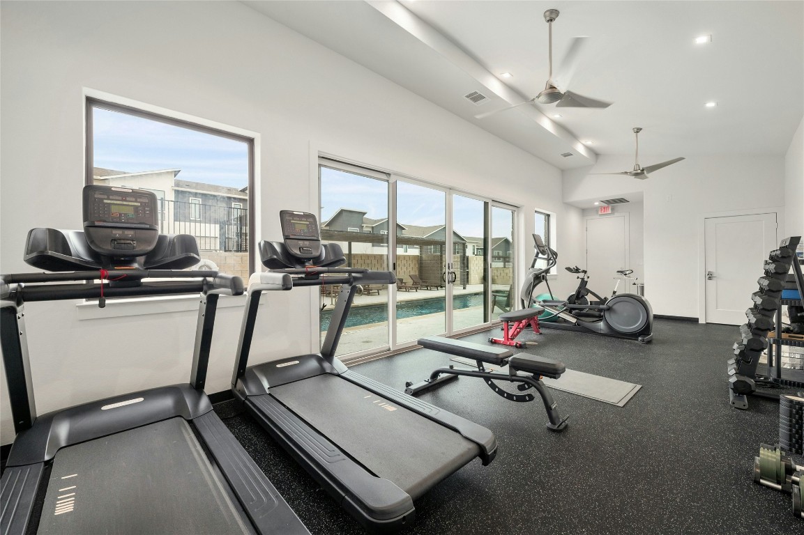 2050 Lohmans Spur Road, Unit 101 Lakeway, TX 78738 - Photo 26 of 31 a room with gym equipment and windows