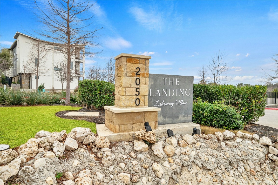 2050 Lohmans Spur Road, Unit 101 Lakeway, TX 78738 - Photo 28 of 31 a front view of a house with garden
