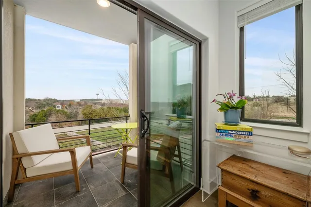 a dining room with furniture and a floor to ceiling window