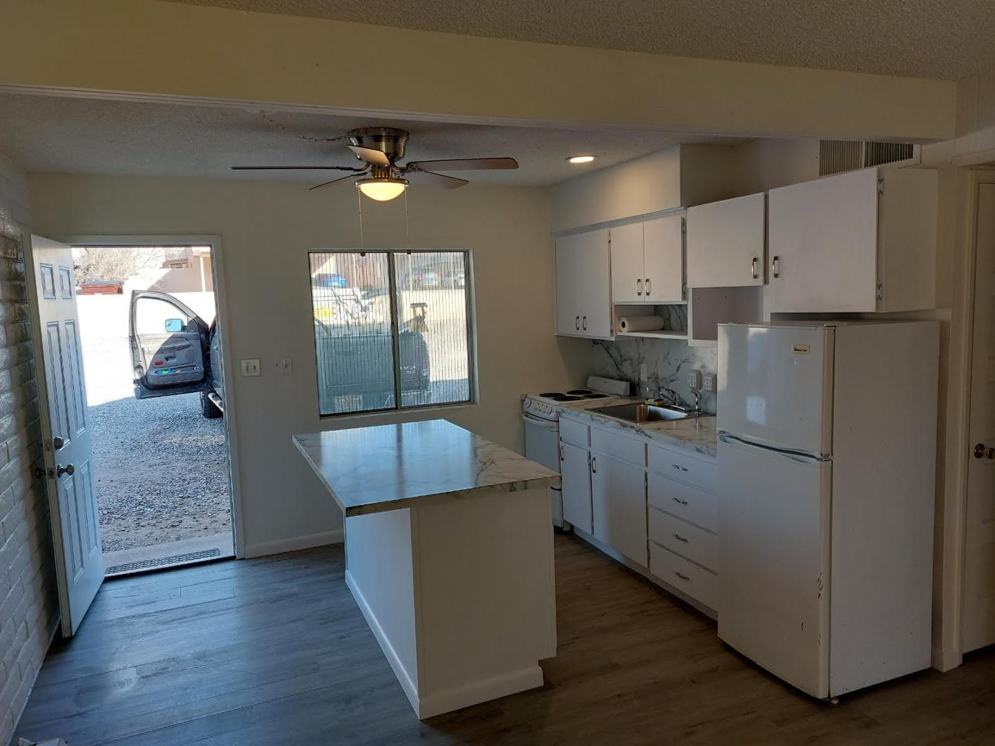 4140 East Cliffside Trail, Unit G Rimrock, AZ 86335 - Photo 14 of 25 a kitchen with kitchen island white cabinets and stainless steel appliances