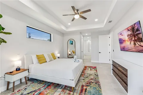 a bedroom with a bed and a chandelier