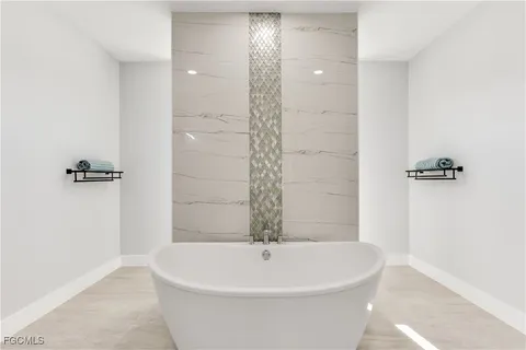 a white bath tub sitting in a bathroom