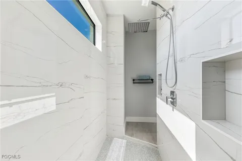 a bathroom with a bathtub and a shower