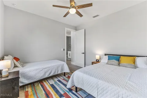 a bedroom with 2 bed and a chandelier