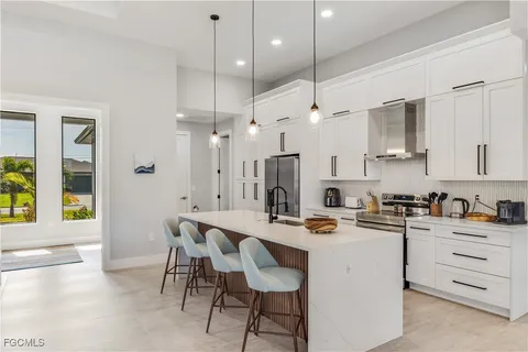 a kitchen that has a lot of cabinets in it and appliances