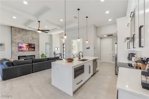 a open kitchen with stainless steel appliances granite countertop a stove and a refrigerator