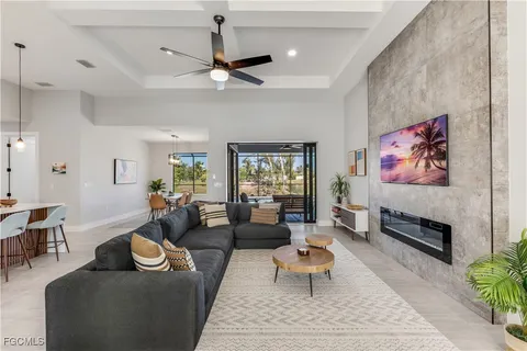 a living room with furniture a rug and a chandelier
