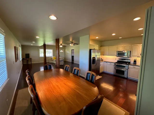 a large kitchen with a table and chairs