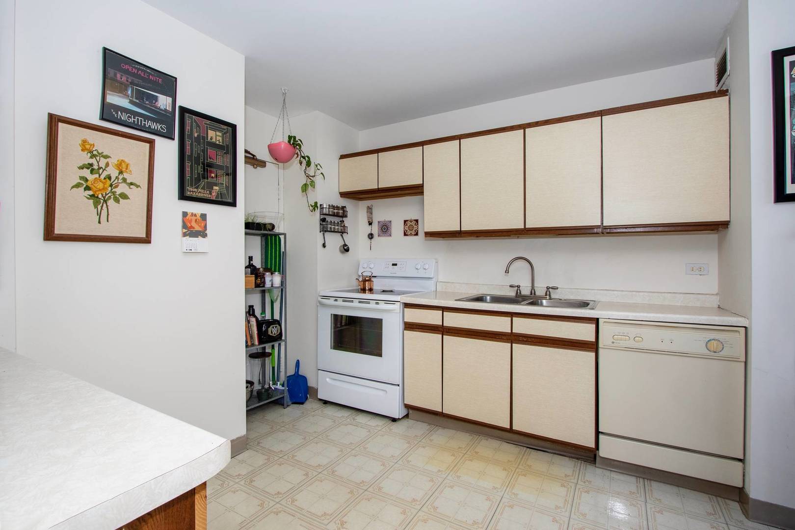 6171 North Sheridan Road, Unit 1112 Chicago, IL 60660 - Photo 5 of 16 a view of cabinets a sink and a stove in a kitchen