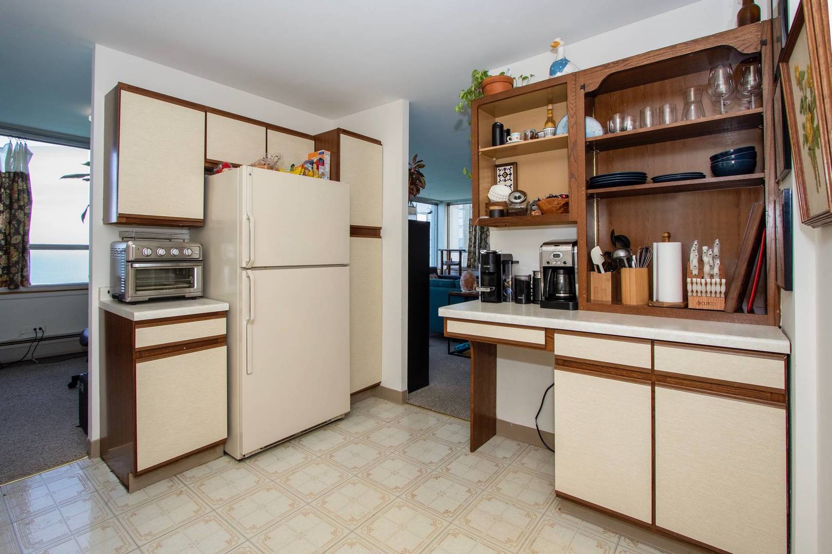 6171 North Sheridan Road, Unit 1112 Chicago, IL 60660 - Photo 6 of 16 a kitchen with stainless steel appliances a refrigerator and cabinets