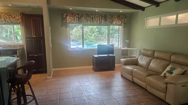 a living room with furniture and a floor to ceiling window