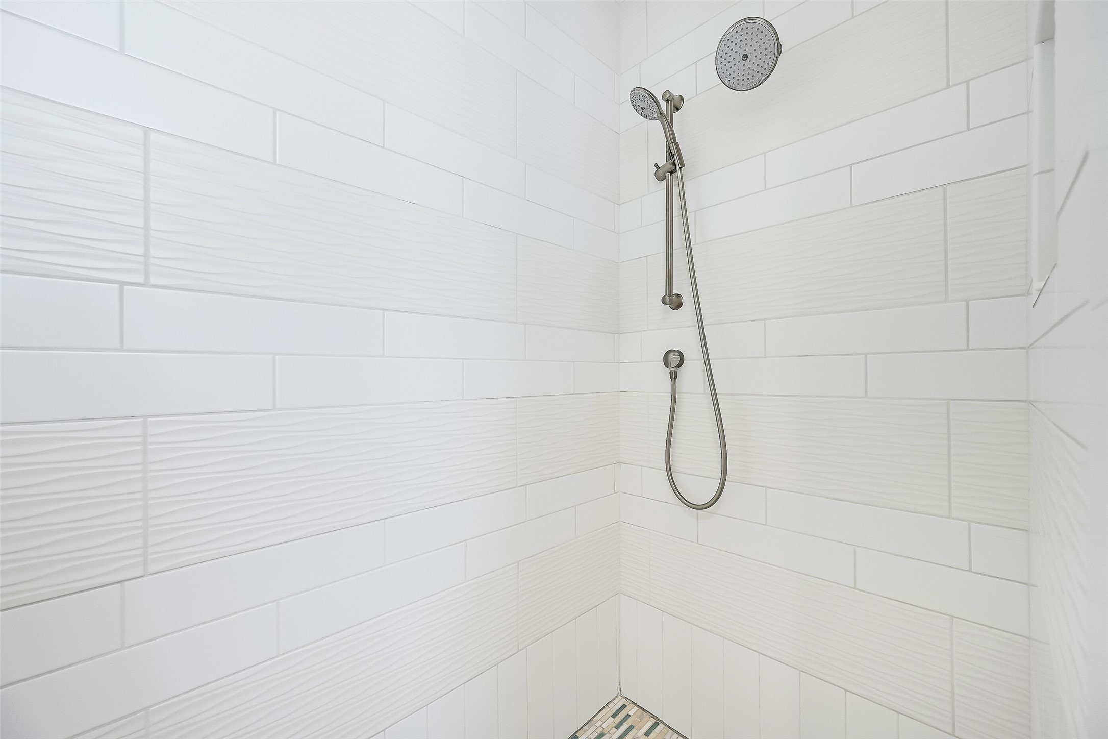 817 Positano Road Galveston, TX 77550 - Photo 30 of 50 Clean lines, elegant tilework, and contemporary fixtures create a sophisticated shower retreat. Designed to complement the home's upscale coastal aesthetic, this space delivers both style and functionality.