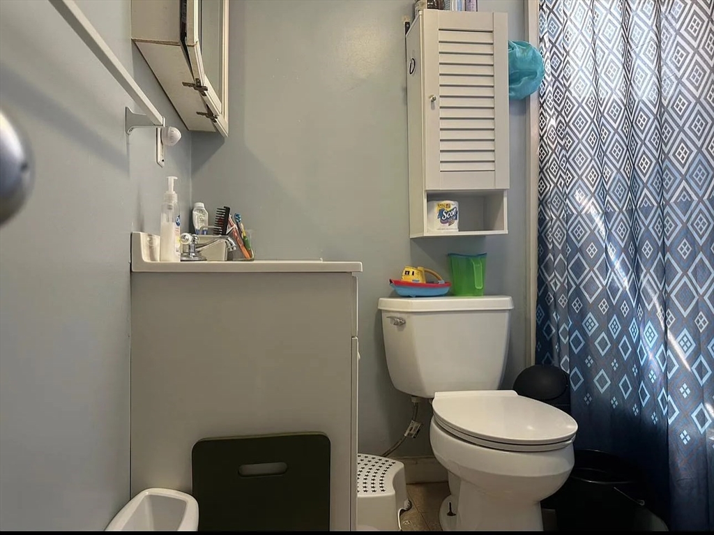 136 Tecumseh Street, Unit 2 Fall River, MA 02721 - Photo 2 of 3 a bathroom with a toilet and a sink