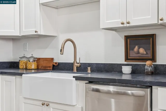a kitchen with appliances a sink and cabinets