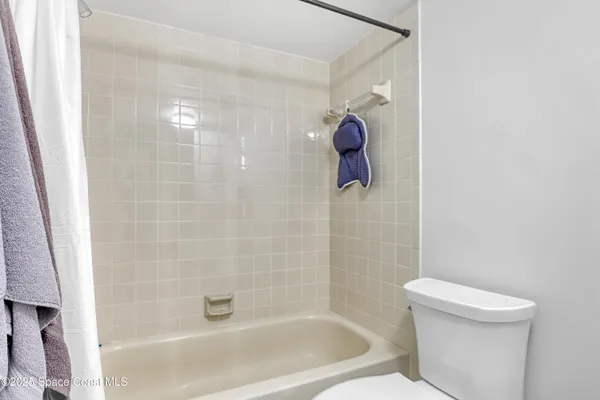 a bath room with a toilet and shower