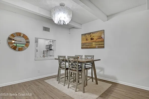 a view of a dining room with furniture and chandelier