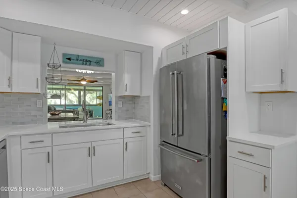 a kitchen with stainless steel appliances a refrigerator sink and cabinets