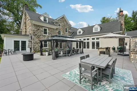 a roof deck with a table and chairs