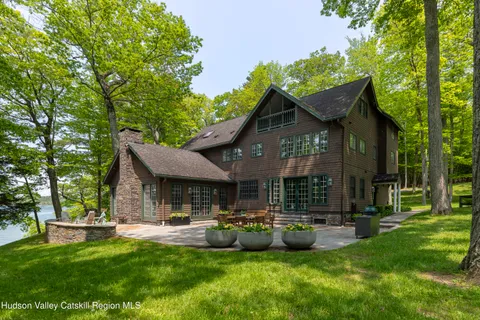 a view of a house with backyard porch and sitting area
