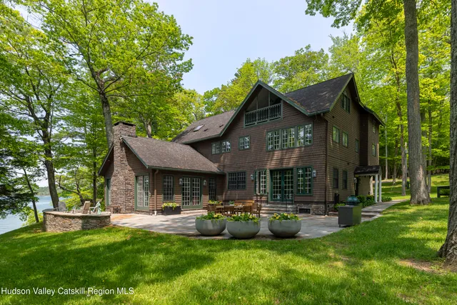 a view of a house with backyard porch and sitting area