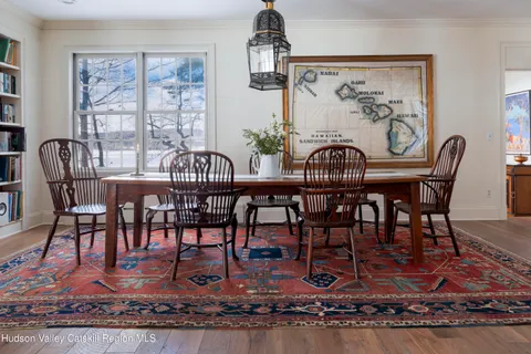 a view of a house with backyard and a tree