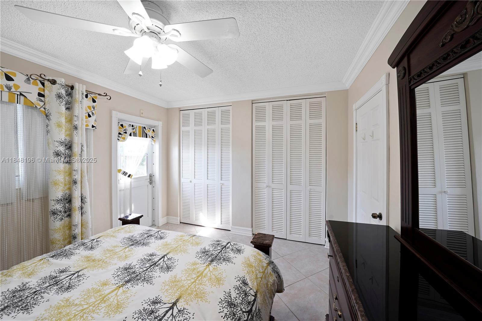 900 Atlantic Shores Boulevard, Unit 215 Hallandale Beach, FL 33009 - Photo 13 of 58 a bedroom with a bed and a chandelier