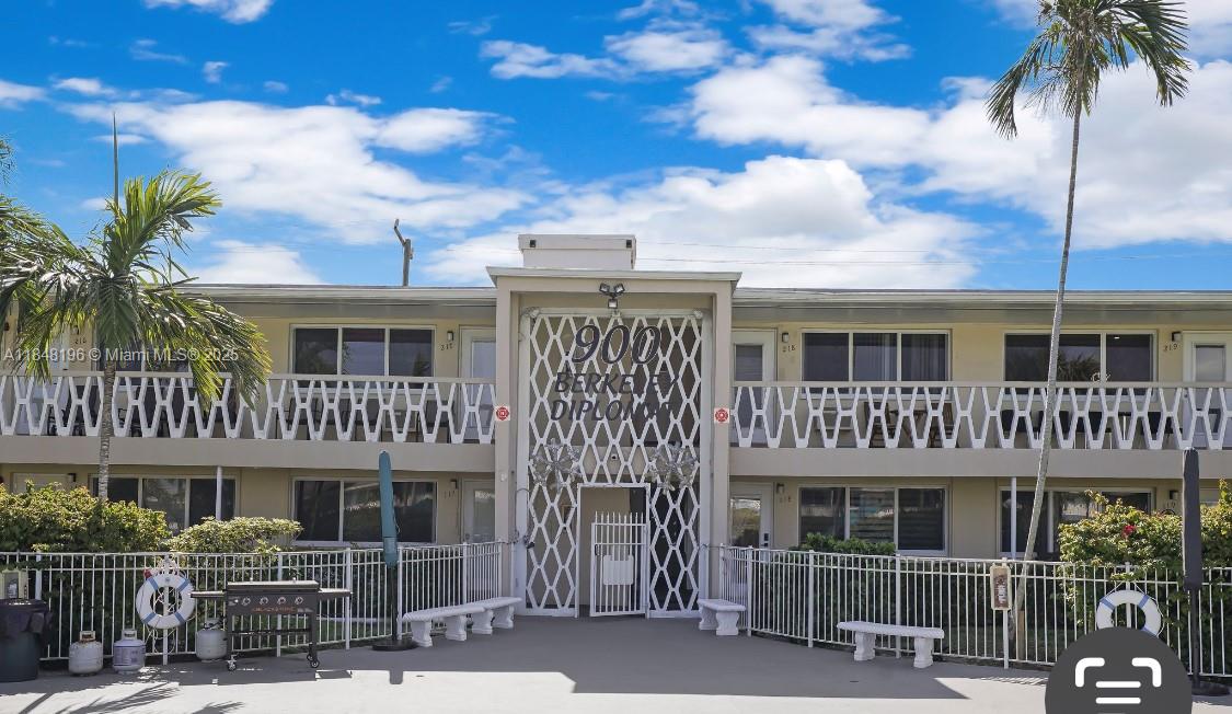 900 Atlantic Shores Boulevard, Unit 215 Hallandale Beach, FL 33009 - Photo 17 of 58 a view of a white building among the palm tree
