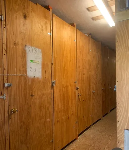 a view of a swimming pool with a yard and large trees