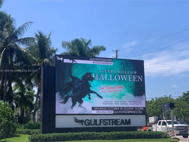a view of a big house with a big yard and a large tree