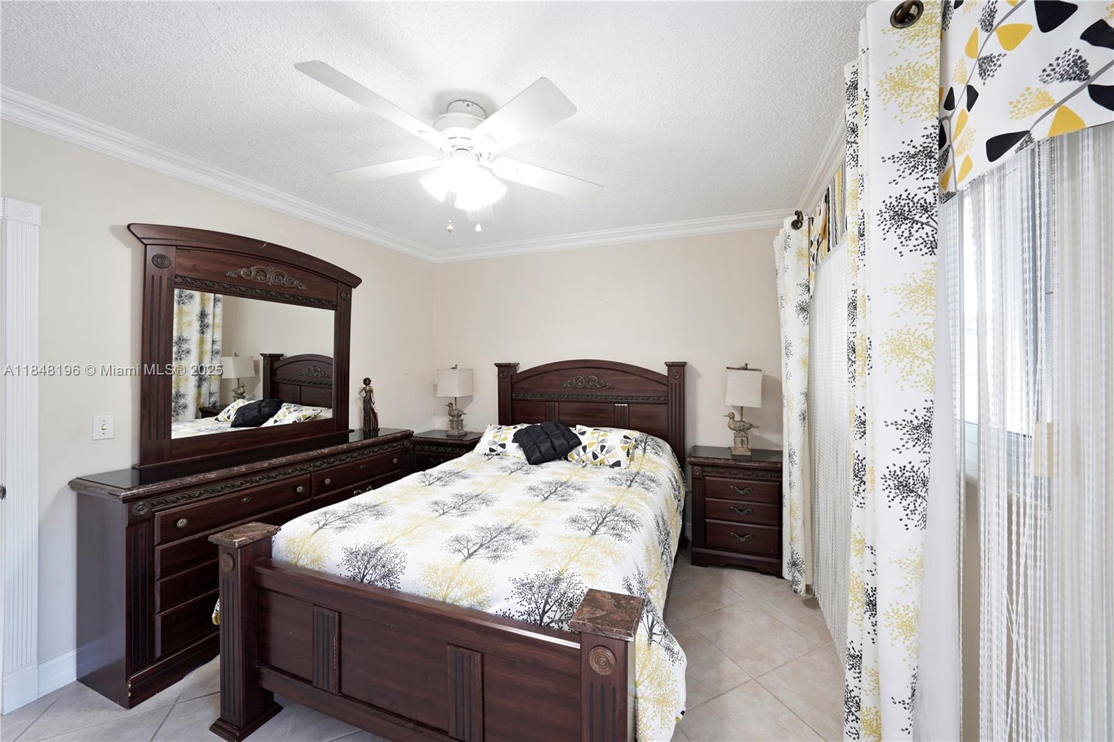 900 Atlantic Shores Boulevard, Unit 215 Hallandale Beach, FL 33009 - Photo 4 of 58 a bedroom with a bed and a mirror with a chandelier