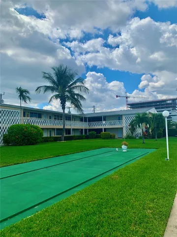 a view of a swimming pool with a lot of trees in the background