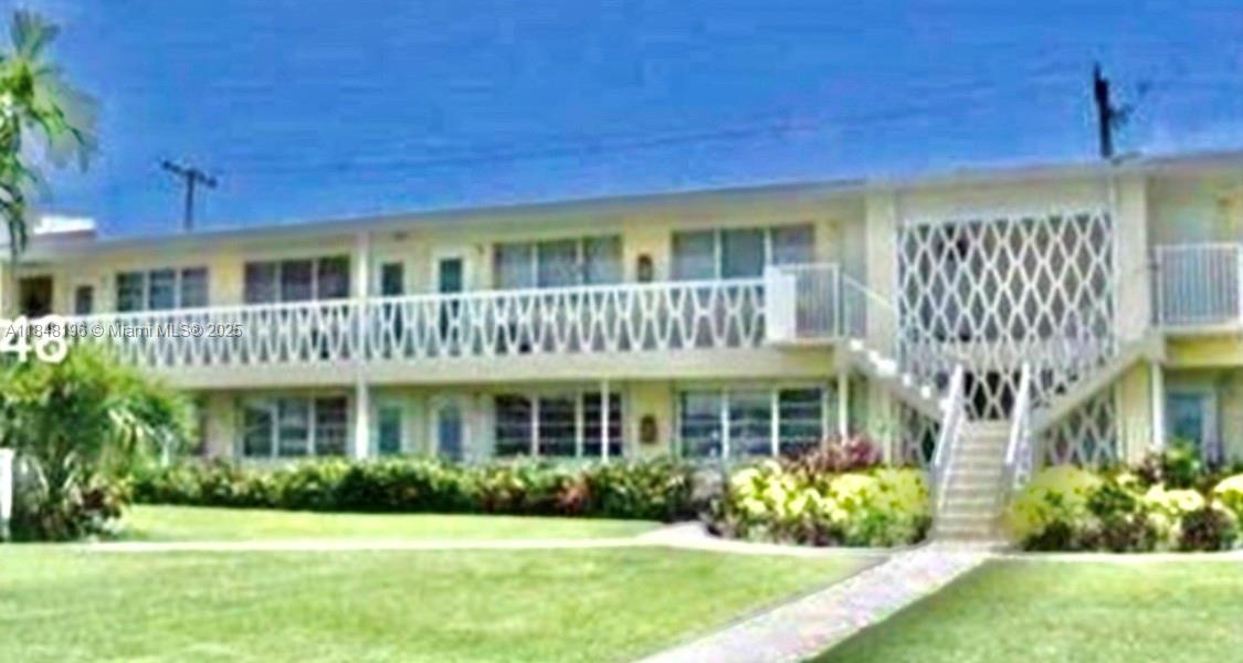 900 Atlantic Shores Boulevard, Unit 215 Hallandale Beach, FL 33009 - Photo 48 of 58 a front view of a house with a yard